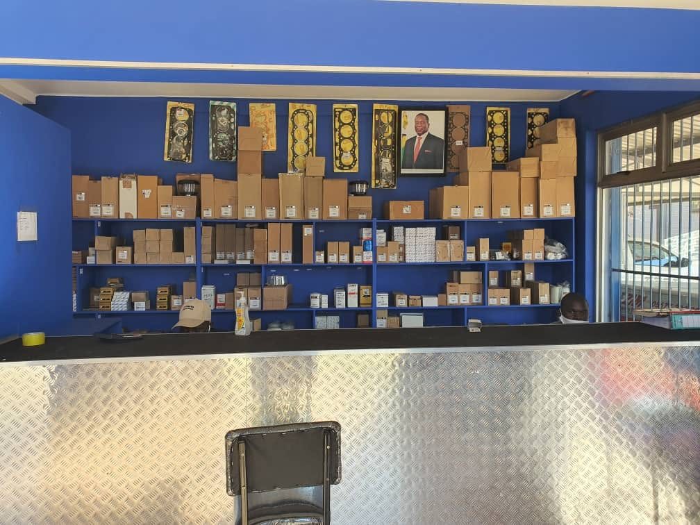 Shelves of boxed tractor spares and head gasket sets behind the Parts Connection counter